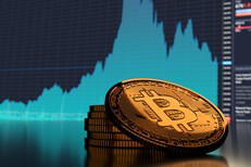 Small stack of Bitcoins in front of blue market area chart showing sharp rise and fall in Bitcoin price