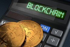 Two Bitcoins laid on a calculator with LCD displaying the word blockchain