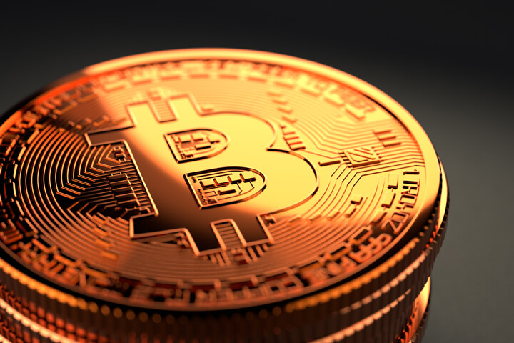 Shiny Bitcoin stack on dark background with sharp golden lighting