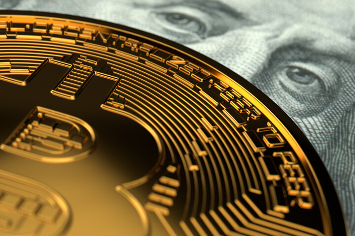 Close-up photo of Bitcoin detail with Benjamin Franklin currency eyes behind it