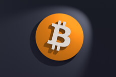 Front view of orange and white Bitcoin B logo on dark wall with spotlight