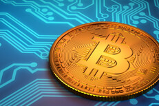 Bitcoin laid on top of blue circuit board representing digital currency or cryptocurrency