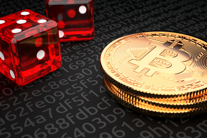 Small stack of Bitcoins with two dice representing Bitcoin investment risk or cryptocurrency risk