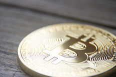Bitcoin with soft back light on weathered wood planks