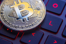 Bitcoin on gamer laptop keyboard with screen back light