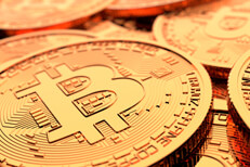 Random pile of Bitcoins with shallow depth-of-field and bright lighting