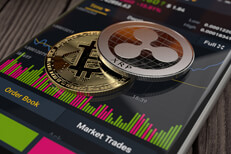 Ripple XRP and Bitcoin on an iPhone screen showing Binance app trading info