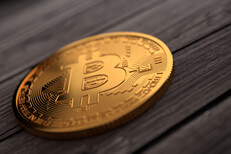 Single gold Bitcoin placed on weathered wood planks with upper right soft light