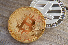Bitcoin with Litecoin on wood background