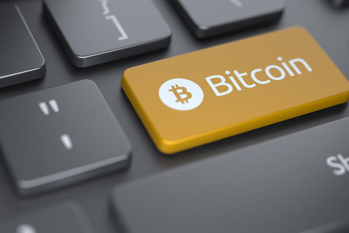 Computer keyboard with orange Bitcoin key