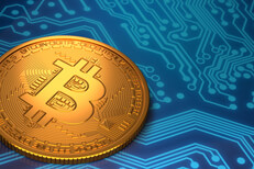 Single Bitcoin laying on blue circuit board