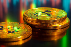 Bitcoins reflecting computer screen showing stock price charts and trading volume