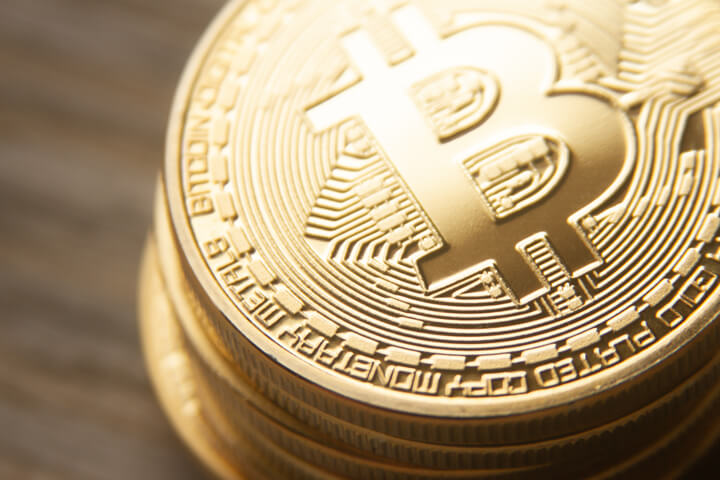 Close view from top of stack of bitcoins with soft back light