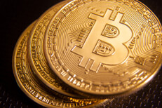 Stack of three Bitcoins offset with depth of field blur