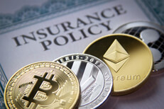 Photo of insurance policy with Bitcoin, Litecoin, Ethereum, and Ripple cryptocurrency coins