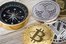 Compass next to crypto coins Navigational compass next to Bitcoin, Litecoin, Ripple, and Ethereum crypto coins