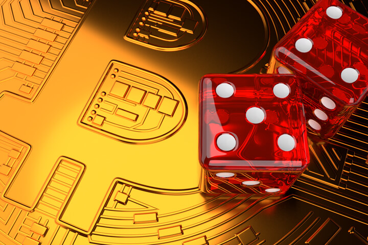 Large shiny Bitcoin with two dice on face representing investment risk in Bitcoin and cryptocurrencies
