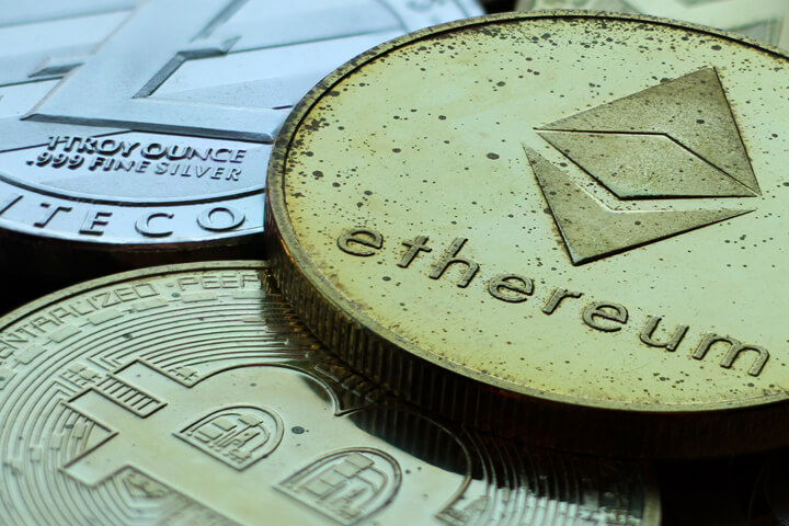 Bitcoin, Litecoin, and Ethereum coin stacked with signs of tarnish and wear