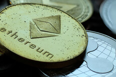 Close up photo of tarnished crypto coins including Ethereum, Ripple XRP, and Monero cryptocurrencies