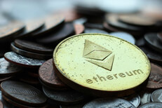 Pile of assorted tarnished U.S. coins with Ethereum coin on top and depth-of-field blur