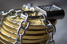 Stack of Bitcoins wrapped with chains and locked with a padlock