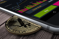 iPhone with Bitcoin inserted into slot concept for mobile Bitcoin apps, profits, or trades