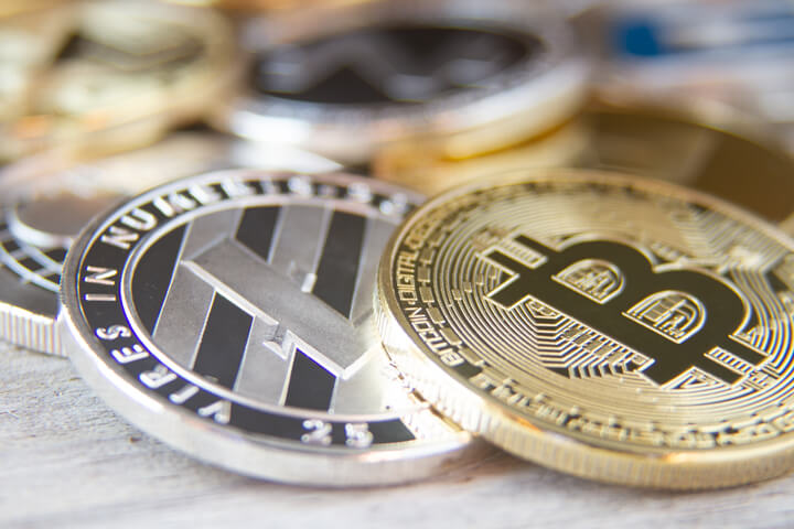 Scattered cryptocurrency coins with focus on Bitcoin and Litecoin