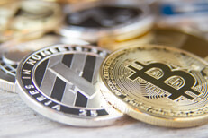 Scattered cryptocurrency coins with focus on Bitcoin and Litecoin