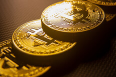 Bitcoins stacked in order with window light in background