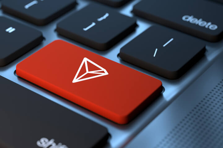 Laptop keyboard with red Tron cryptocurrency key