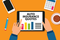 Desktop showing hands holding tablet or iPad with auto insurance quotes bar chart showing different prices