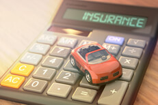 Insurance calculator with small red toy car and light flare effect