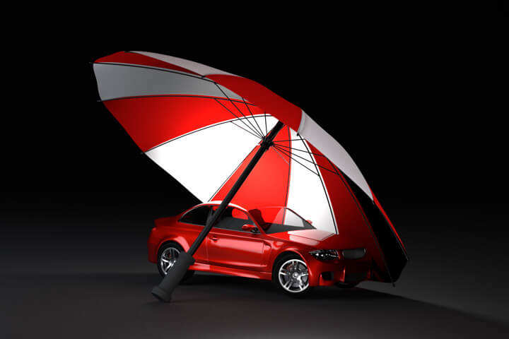 Insurance protection concept of red car under red and white umbrella with dark background