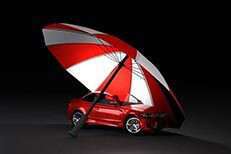 Insurance protection concept of red car under red and white umbrella with dark background