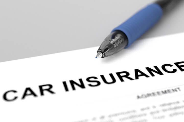Car insurance policy close up image with ink pen