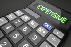Calculator with LCD showing Expensive to illustrate high cost concept