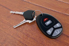 Car keys and clicker on wood desk