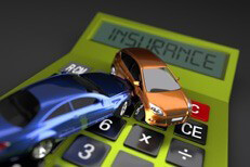 Two cars in accident on bright green calculator displaying insurance on darker background