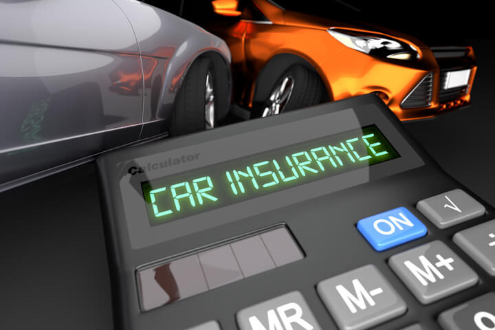 Two car accident in background with calculator LCD showing Car Insurance in foreground