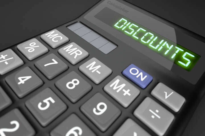 Calculator showing LCD word Discounts on dark background