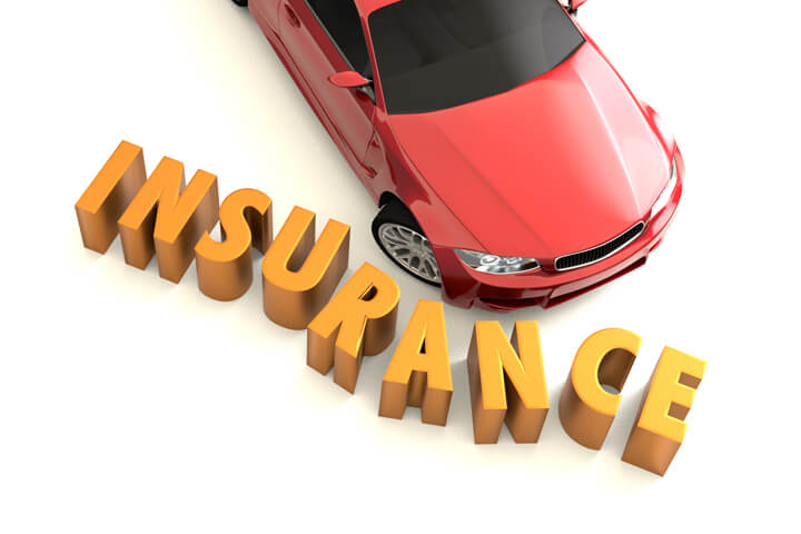 Overhead image of car crashing into insurance letters concept