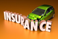 Small green compact car crashed into insurance word on orange background
