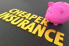 Pink piggy bank with shiny gold Cheaper Insurance words on road