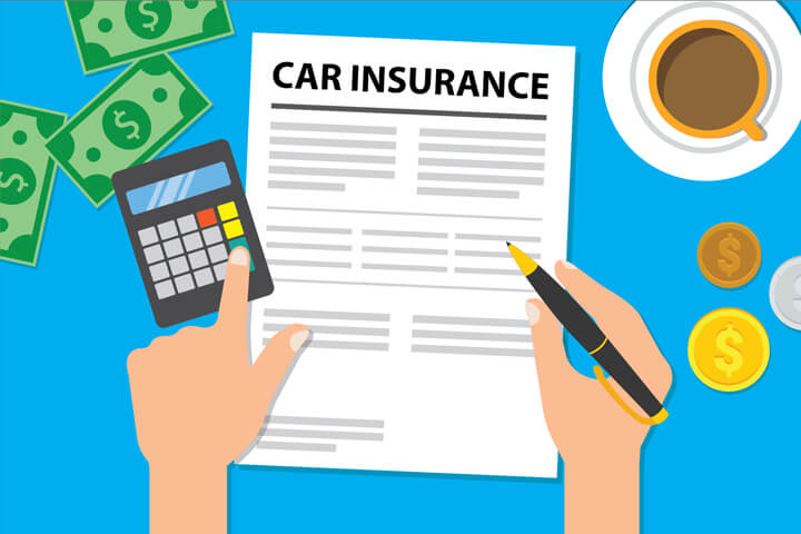 Desk with car insurance policy, toy car, coffee cup, money, and calculator with hand holding pen and touching key on calculator
