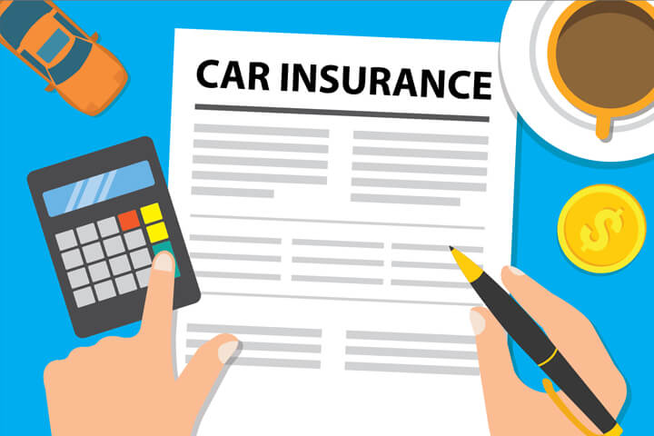 Desk with car insurance policy, toy car, coffee cup and calculator with hand holding pen and touching key on calculator