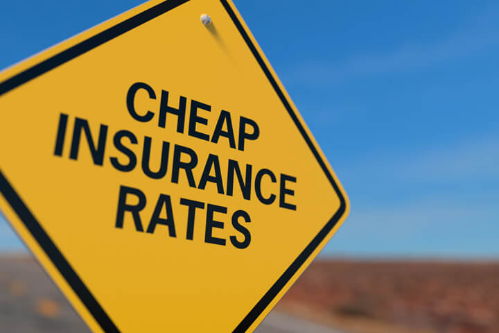 Yellow road sign reading Cheaper Insurance Rates