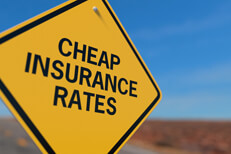 Yellow road sign reading Cheaper Insurance Rates