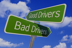 Street sign with arrows reading Good Drivers and Bad Drivers pointing in opposite directions