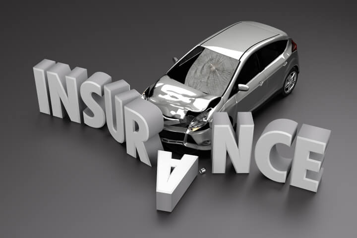 Black and white image of car crashed into insurance letters with front end damage