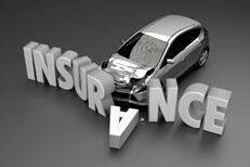 Black and white image of car crashed into insurance letters with front end damage